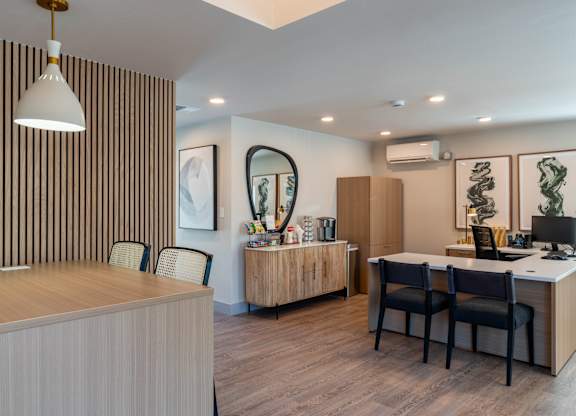 A modern office with a striped wallpaper and a wooden desk.