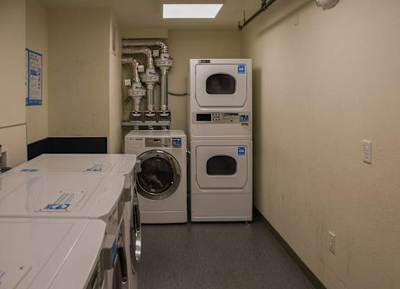 A laundry room with washers and dryers.