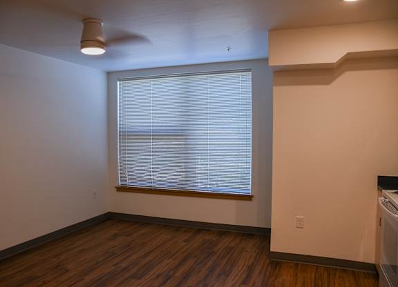 A room with a window and a ceiling fan.