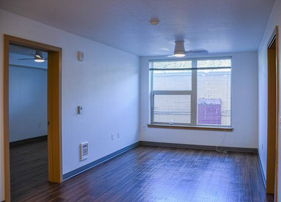 A room with a window and a ceiling fan.