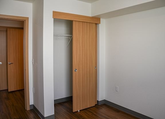 A white wall with a brown door and a white wall with a brown door.