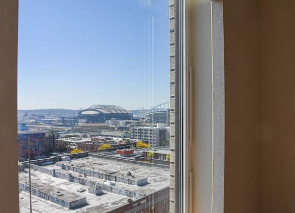 A view from a window looking out at a cityscape.