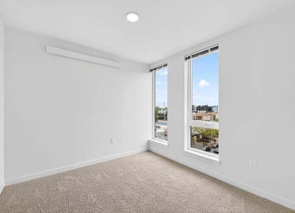 Empty bedroom with natural light at Victory Northgate Apartments, Seattle, Washington