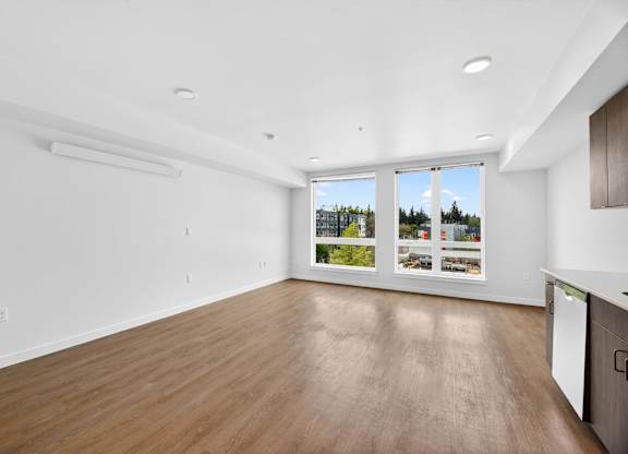 Spacious living room with wood flooring at Victory Northgate Apartments, Seattle, 98125