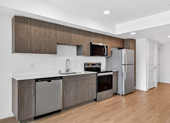 Fully equipped kitchen with wood flooring at Victory Northgate Apartments, Seattle
