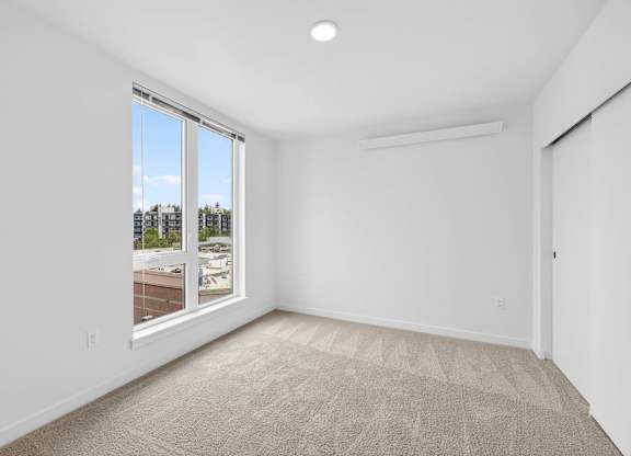 Bedroom with beige carpeting at Victory Northgate Apartments, Seattle, 98125