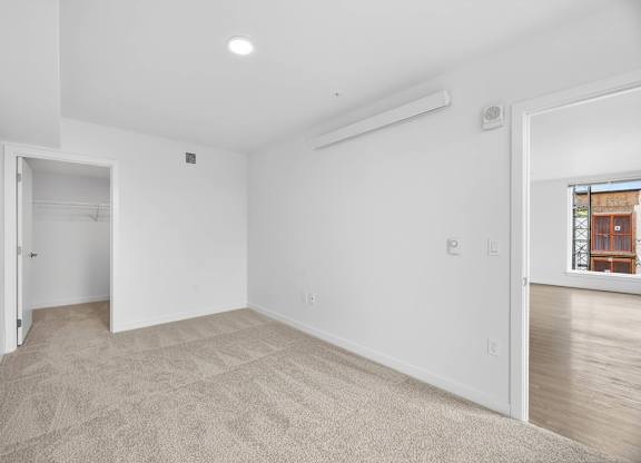 Bedroom interior with white walls at Victory Northgate Apartments, Washington