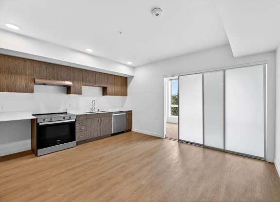 Spacious living room with kitchen attached at Victory Northgate Apartments, Washington