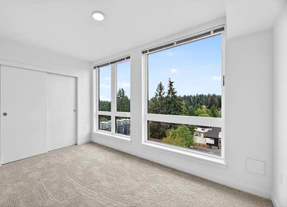 Bedroom with white walls and carpeting at Victory Northgate Apartments, Seattle, Washington