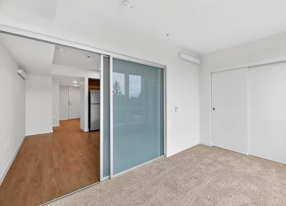 Bedroom area with living room view at Victory Northgate Apartments, Washington
