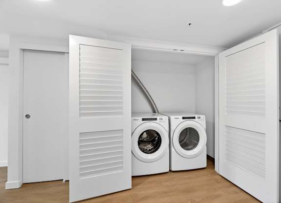 Closet view with washer and dryer at Victory Northgate Apartments, Seattle, WA