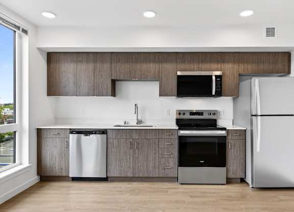 Modern style kitchen with stainless steel appliances at Victory Northgate Apartments, Seattle, WA, 98125
