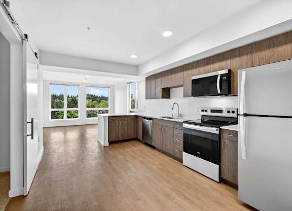 Kitchen with appliances and white walls at Victory Northgate Apartments, Seattle