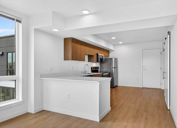 Kitchen with a breakfast bar at Victory Northgate Apartments, Seattle, WA