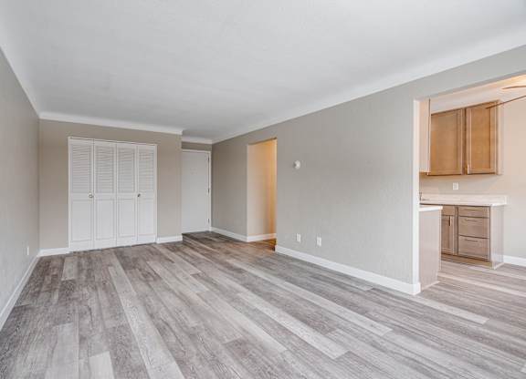 A room with a white door and a wooden floor.