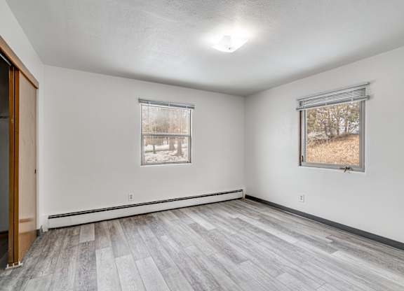 A room with a window and a door.