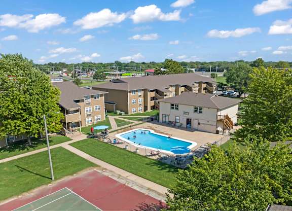 A pool and tennis court are part of the outdoor recreational facilities at this apartment complex.