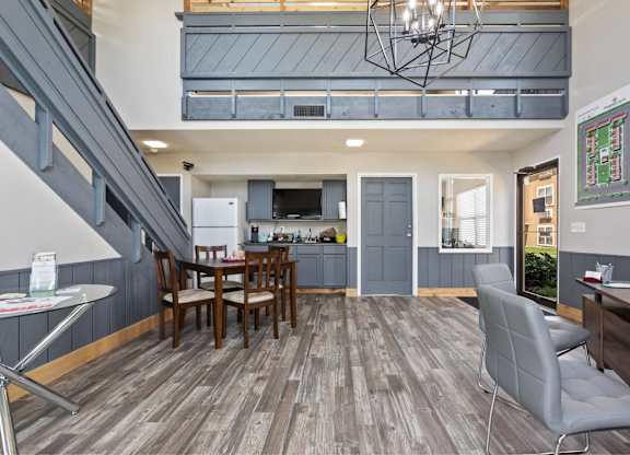A modern open plan living and dining area with a grey chair.