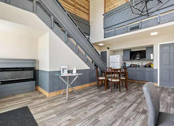 A living room with a grey couch and a wooden floor.