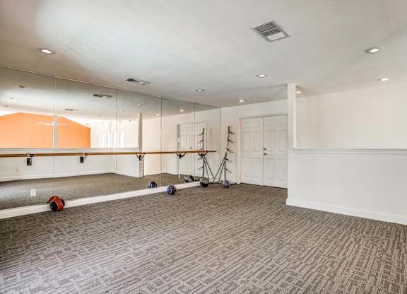 A room with a grey carpet and a white ceiling.