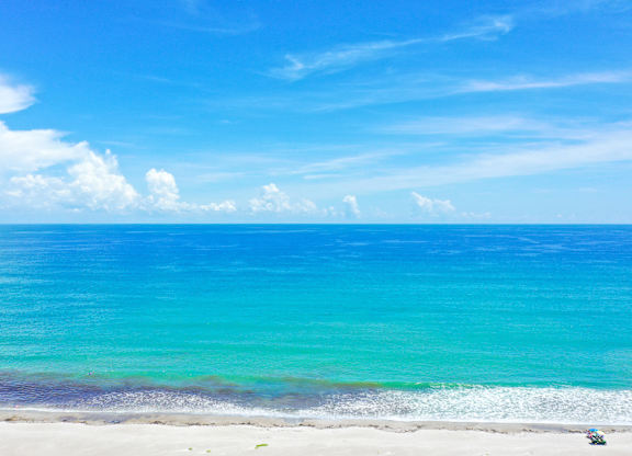 A beautiful beach with white sand and blue water.