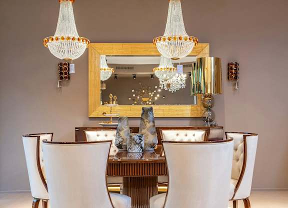 A dining room with a large table and chairs.