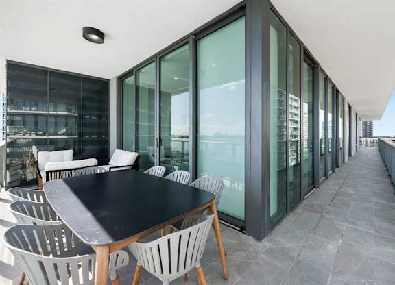 A modern dining area with a long table and chairs.