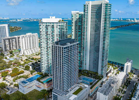 A cityscape with a large body of water in the background.