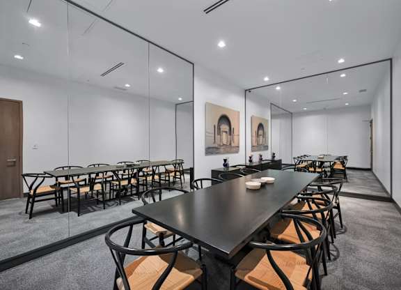 A conference room with a long table and chairs.