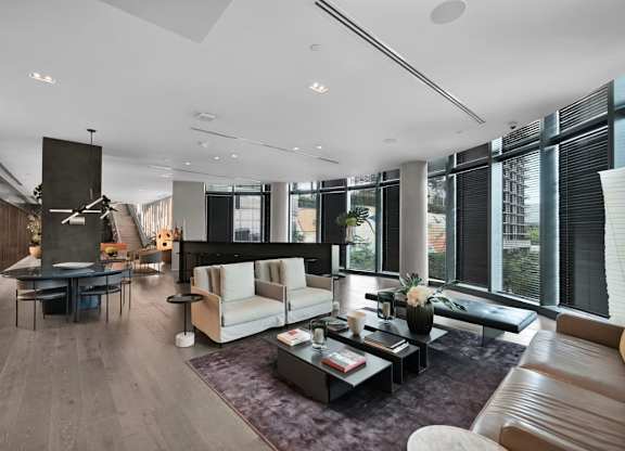 A modern living room with a fireplace and a large window.