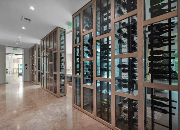 A wine cellar with a glass door and a marble floor.