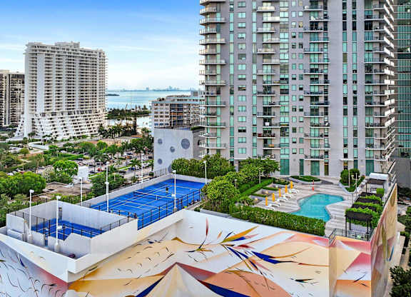 A large building with a pool and a mural on the side.