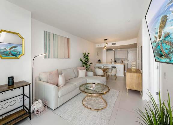 A living room with a white couch and a coffee table.