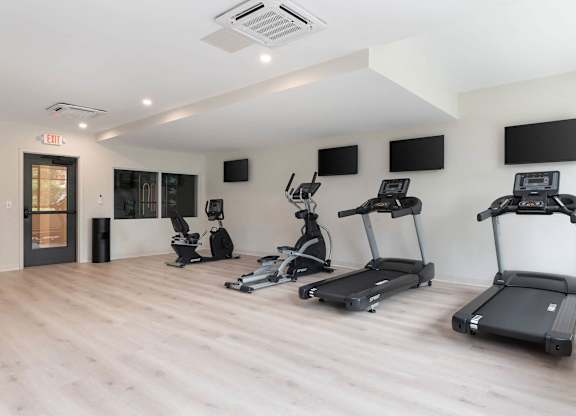A gym with treadmills and exercise bikes.