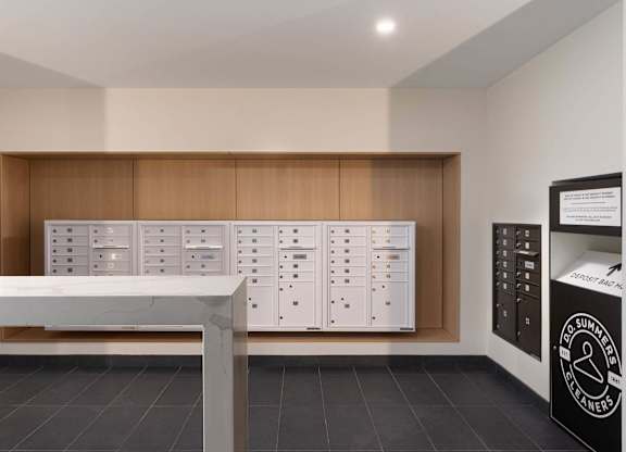 A modern kitchen with a white counter and wooden cabinets.
