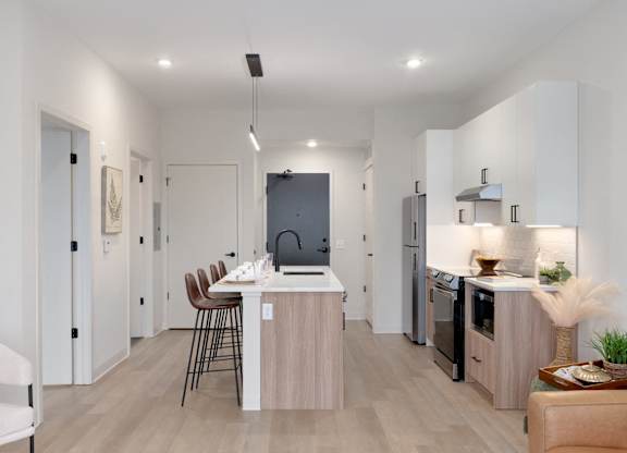 A modern kitchen with a dining table and chairs.