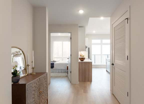 A bedroom with a bed, a dresser, and a mirror.