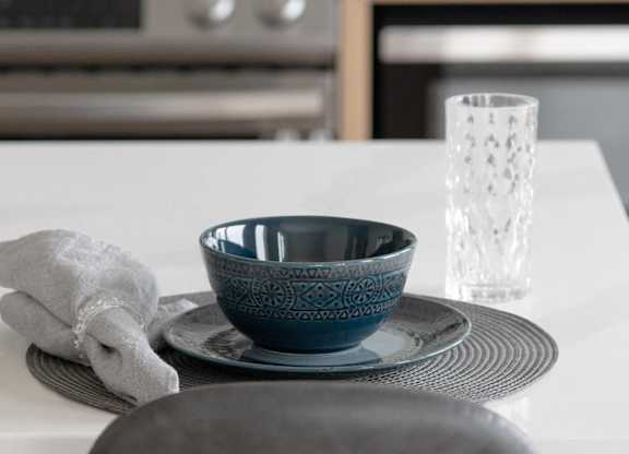 A bowl on a plate on a chair.