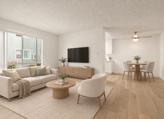 A living room with a couch, chairs, and a television.