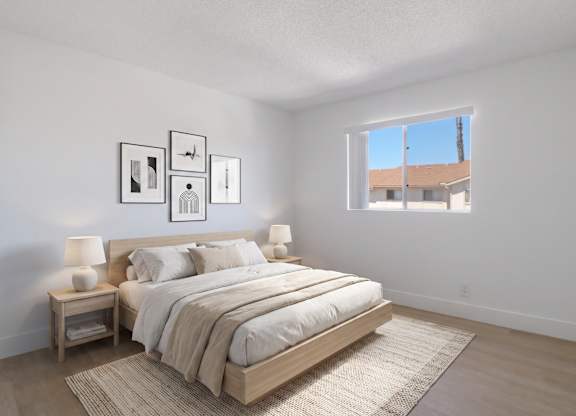 A bedroom with a large bed and a window overlooking a building.