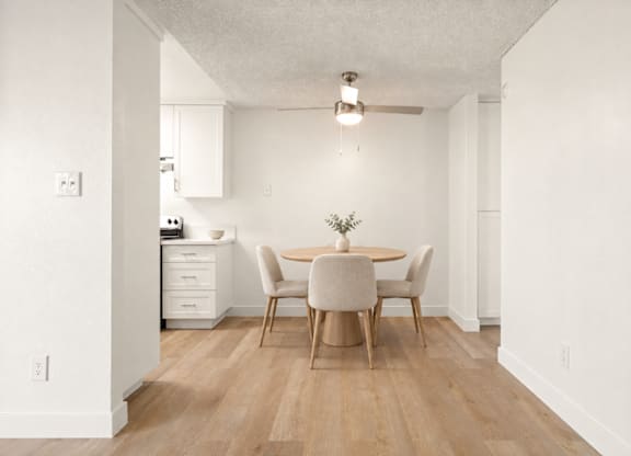 A dining room with a table and chairs.