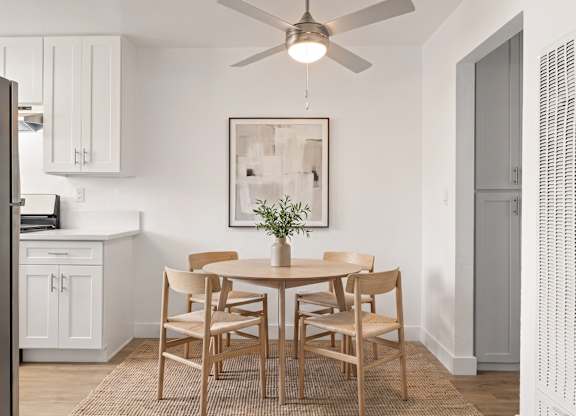 A dining room with a table set for six.