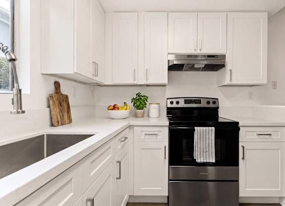 A modern kitchen with a black stove top oven.