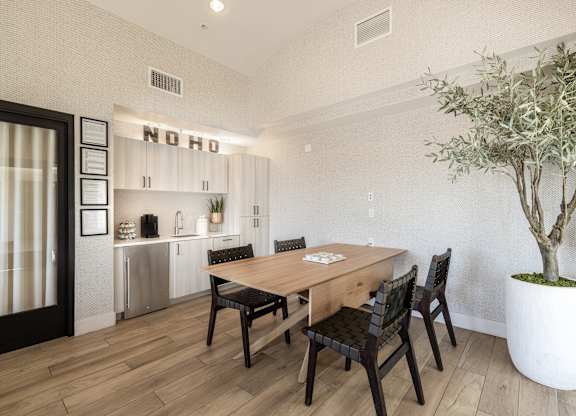A dining room with a wooden table and chairs.