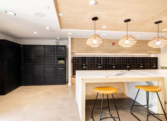 A modern kitchen with a white counter and black cabinets.