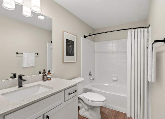 A bathroom with a white toilet and a white shower curtain.