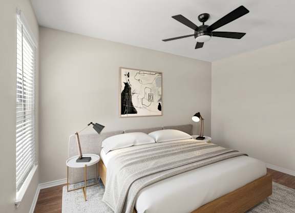 A bedroom with a bed, two lamps, and a painting on the wall.