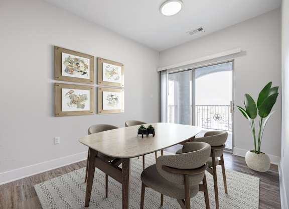 A dining room with a table and chairs.
