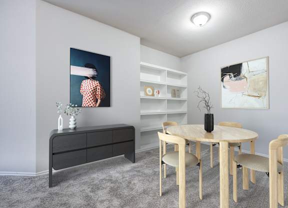 A room with a round table and chairs, a dresser, and two paintings on the wall.