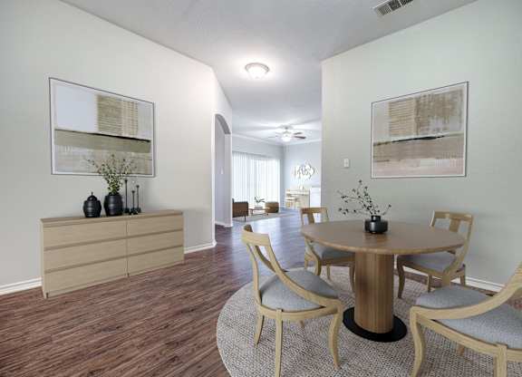 A dining room with a round table and chairs.